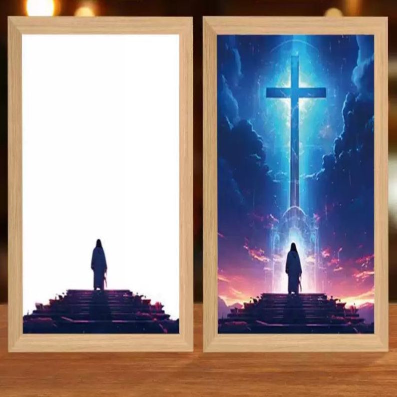 Two framed artworks depicting silhouettes on steps with a cross and bright light in the background.