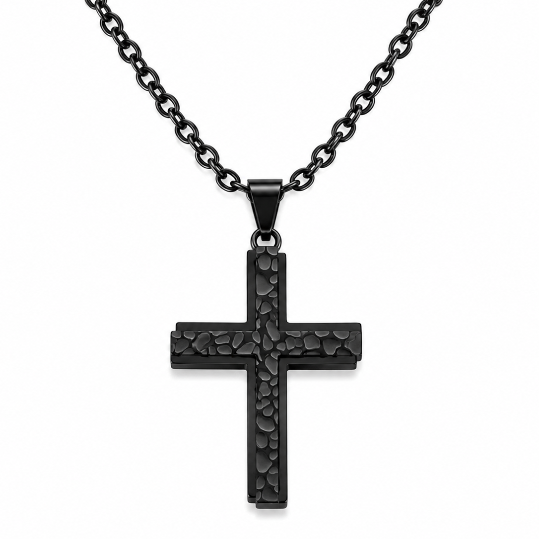 A black cross pendant necklace with a textured, hammered finish on a matching black link chain, shown against a plain white background.