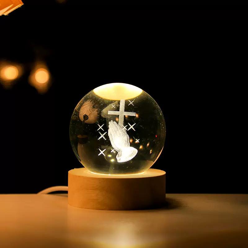 Glowing crystal ball with a wooden base on a dark background