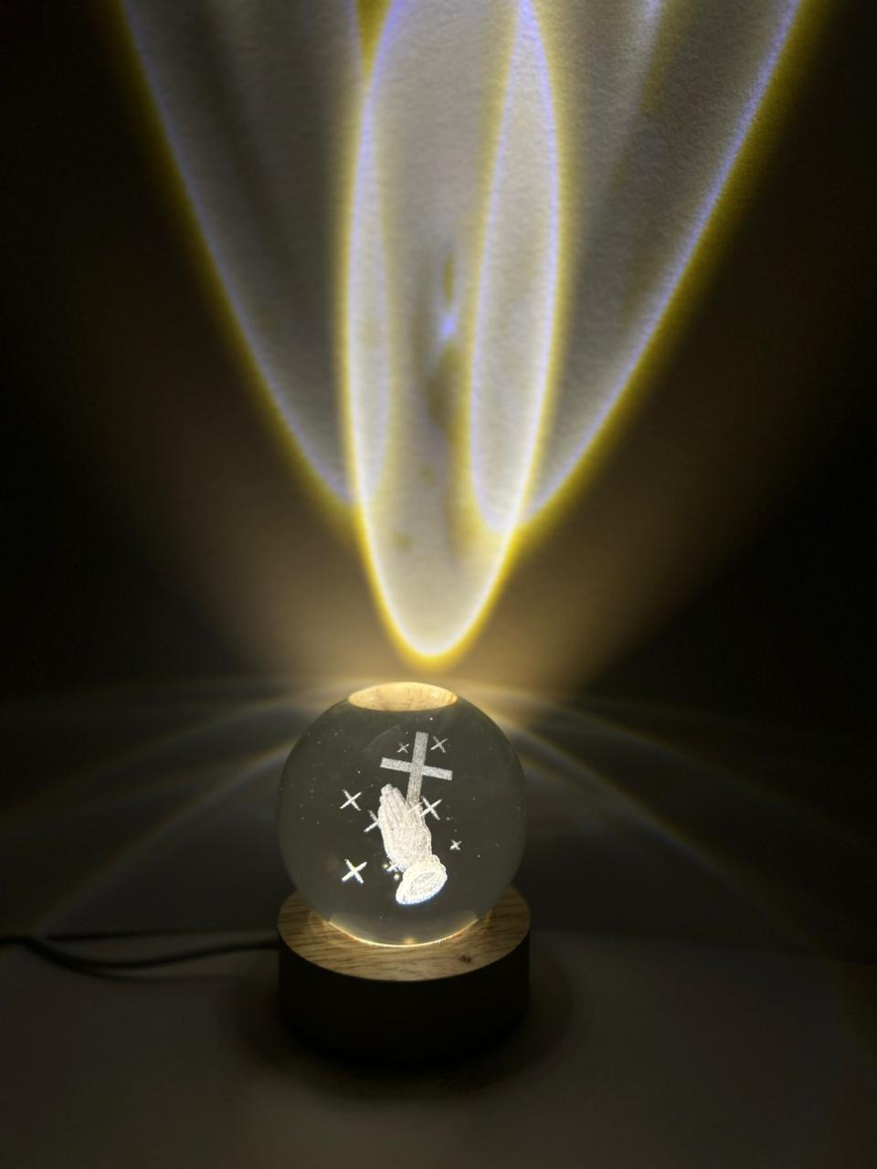 Decorative light bulb with a religious design on a dark background