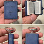 Miniature blue 'HOLY BIBLE' keychain held in a hand.