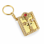 Gold keychain with a religious design on a white background