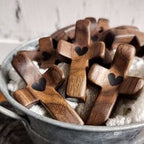 Wooden crosses with heart shapes in a metal bucket